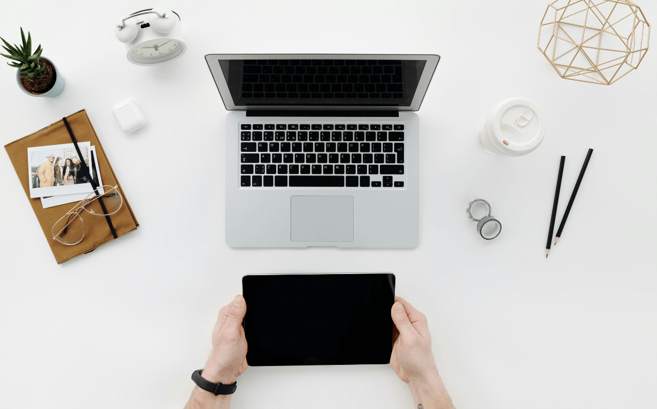 A tablet, laptop and other office items on a desk